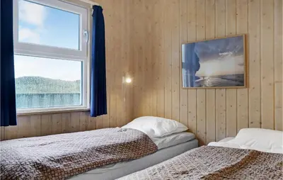 a bedroom with two beds and a window at Holiday Home Kløvborgsti Thisted Ix in Thisted