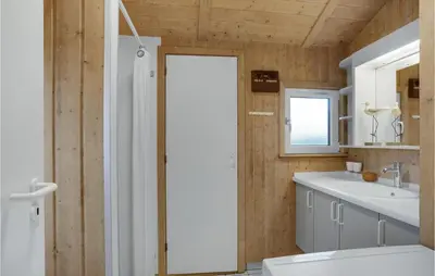 a bathroom with a shower and a toilet and a sink at Holiday Home Kløvborgsti Thisted Ix in Thisted