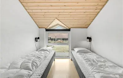 a row of beds in a room with a window at Amazing Home In Thisted With Sauna in Thisted