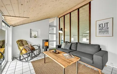 a living room with a couch and a table at Amazing Home In Thisted With Sauna in Thisted