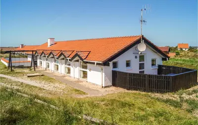 a house with an orange roof and a black fence at Amazing Home In Thisted With Sauna in Thisted
