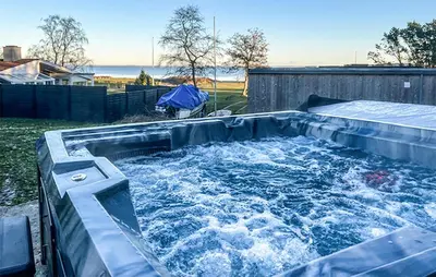 a large plunge pool with water in a backyard at Rishøj in Løgstrup