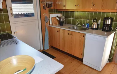 a kitchen with a sink and a counter top at Holiday Home Fjordparken Farsø Iv in Farsø