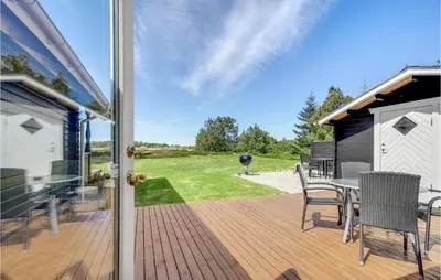 a patio with a table and chairs on a deck at Holiday Home Venøvej Højslev Denm in Højslev