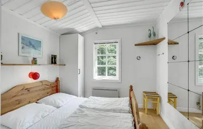 a white bedroom with a bed and a window at Holiday Home Venøvej Højslev Denm in Højslev