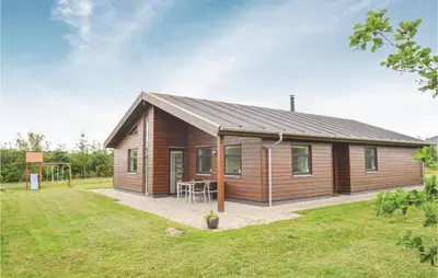 a small wooden house with a grass yard at Holiday Home Bronzehøjen Højslev in Højslev