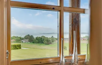 a window with a view of a green field at Holiday Home Husvej in Fur
