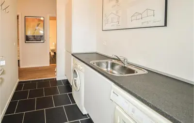 a kitchen with a sink and a dishwasher at Holiday Home Marthasvej in Løgstør