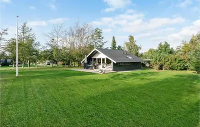 a small house in a field with a large yard at Holiday Home Agathesvej Løgstør V in Løgstør