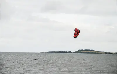 a person is flying a kite in the water at Holiday Home Hellesvej Løgstør Xi in Løgstør