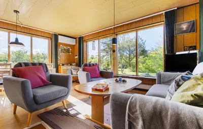 a living room with couches and a table at Holiday Home Bjarkesvej in Farsø