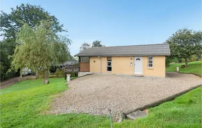 a house with a large yard in front of it at Holiday Home Eskovvej in Roslev
