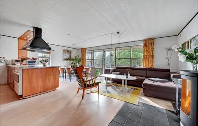 a living room with a couch and a table at Holiday Home Eskovvej in Roslev