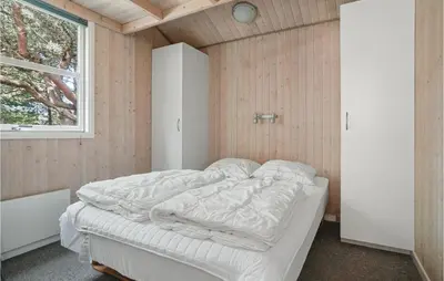 a bedroom with a bed in a room with a window at Holiday Home Revlingestien Fjerritslev V in Fjerritslev