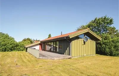 a small house with a deck on a field at Holiday Home N C Alstedsvej Fjerritslev Xii in Fjerritslev