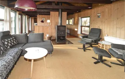 a living room with a couch and chairs and a piano at Holiday Home N C Alstedsvej Fjerritslev Xii in Fjerritslev