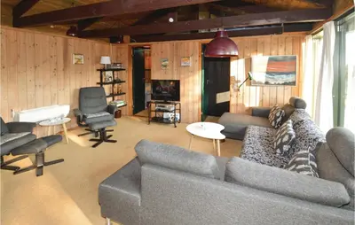 a living room with a couch and a piano at Holiday Home N C Alstedsvej Fjerritslev Xii in Fjerritslev