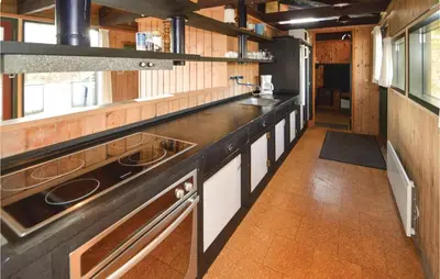 a kitchen with a long counter in a room at Holiday Home N C Alstedsvej Fjerritslev Xii in Fjerritslev