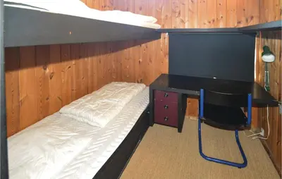 a bunk bed in a room with a desk at Holiday Home N C Alstedsvej Fjerritslev Xii in Fjerritslev