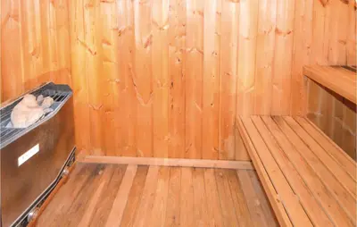 a sauna with wooden walls and a wooden floor at Holiday Home N C Alstedsvej Fjerritslev Xii in Fjerritslev
