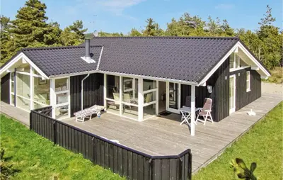 a modular home with a deck and a house at Holiday Home Revlingestien Fjerritslev Iv in Fjerritslev