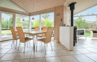 a dining room with a table and chairs at Holiday Home Revlingestien Fjerritslev Iv in Fjerritslev