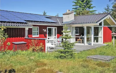 a red house with solar panels on it at Holiday Home Revlingestien Fjerritslev Denm in Fjerritslev