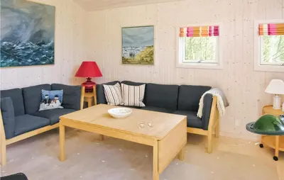 a living room with a couch and a coffee table at Holiday Home Revlingestien Fjerritslev Denm in Fjerritslev