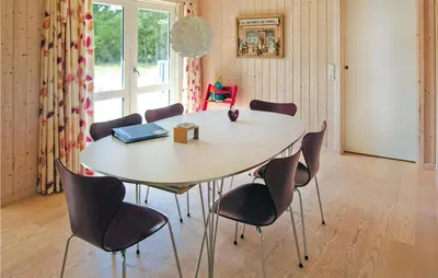a table and chairs in a room with a window at Holiday Home Revlingestien Fjerritslev Denm in Fjerritslev