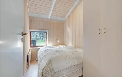 a bedroom with a bed and a window at Holiday Home Rønnevej Fjerritslev Ix in Fjerritslev