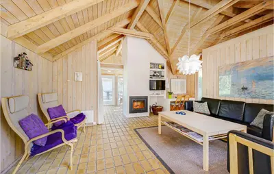 a living room with a couch and a table at Holiday Home Tulipanvej Fjerritslev I in Fjerritslev