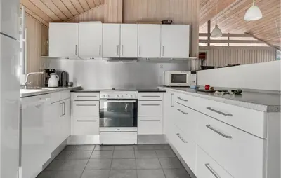 a white kitchen with white cabinets and white appliances at 4 Bedroom Gorgeous Home In Fjerritslev in Fjerritslev