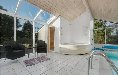 a bathroom with a tub and a swimming pool at 4 Bedroom Gorgeous Home In Fjerritslev in Fjerritslev