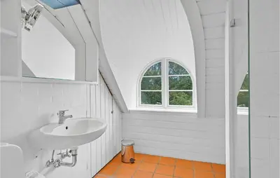 a white bathroom with a sink and a window at Pee Klims Hus in Brovst