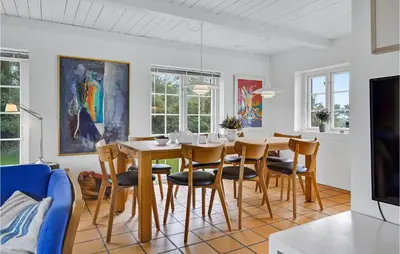 a dining room with a table and chairs at Pee Klims Hus in Brovst