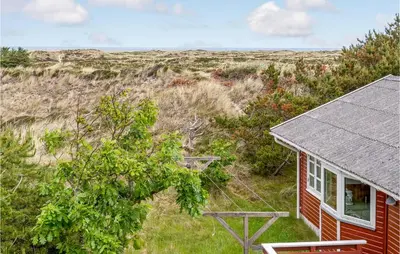 a small red house in the middle of a field at Holiday Home Svenstibakkevej Denmark Ii in Frøstrup