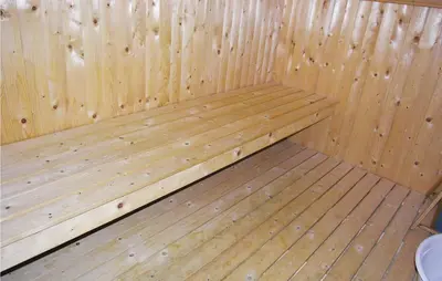 a wooden paneled sauna with a bench in it at Holiday Home Svenstibakkevej Frøstrup Iv in Frøstrup