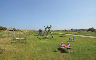 a group of children playing in a park at Holiday Home Svenstibakkevej Frøstrup Iv in Frøstrup