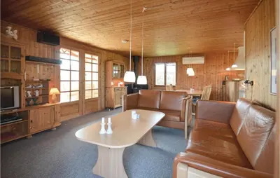 a living room with a couch and a table at Holiday Home Svenstibakkevej Frøstrup Iv in Frøstrup
