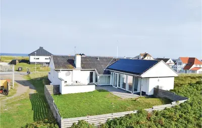 a white house with a blue roof at Gorgeous Home In Frøstrup With Wifi in Frøstrup