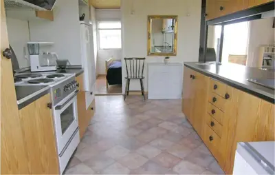 a kitchen with a stove and a counter top at Holiday Home Svenstibakkevej Frøstrup Xii in Frøstrup