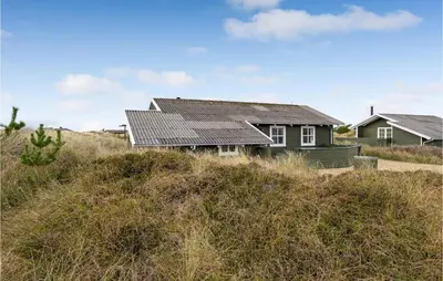 a house on top of a grassy hill at Holiday Home Svenstibakkevej Denmark in Frøstrup
