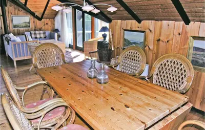 a wooden table and chairs in a room at Holiday Home C J Thaningsvej Fjerritslev X in Fjerritslev