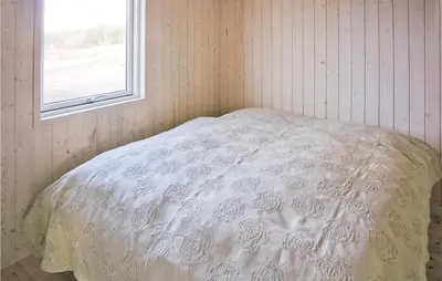 a white bed in a room with a window at Holiday Home Aspevej Fjerritslev Xi in Fjerritslev