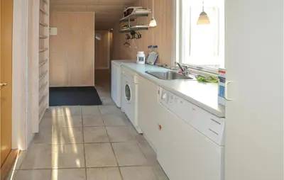 a kitchen with a sink and a washing machine at Jydehuset in Fjerritslev