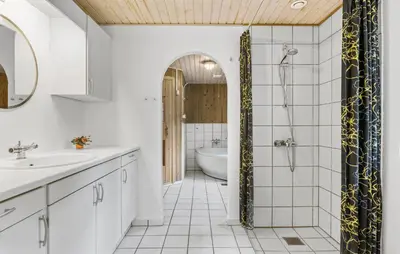 a bathroom with a shower and a sink and a tub at Holiday Home Strandvejen Brovst Denm in Brovst