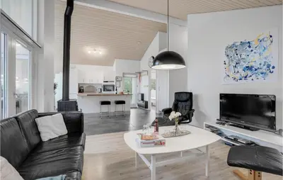 a living room with a couch and a table at Holiday Home Kronvildtvej Brovst I in Brovst