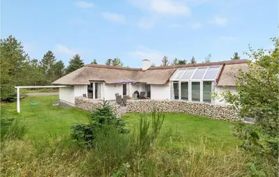 a white house with a stone wall at Gorgeous Home In Fjerritslev With Wifi in Fjerritslev