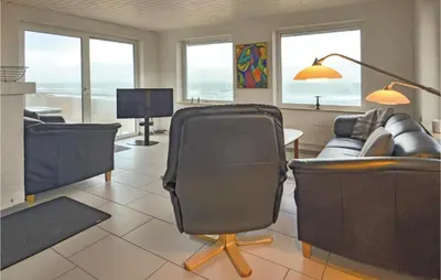 a living room with two chairs and a couch at Holiday Home Sandnæshagevej Frøstrup Iv in Frøstrup