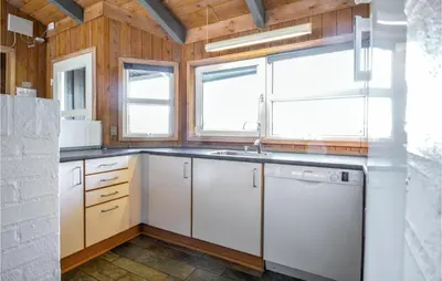 a kitchen with white cabinets and a sink and windows at 4 Bedroom Stunning Home In Fjerritslev in Fjerritslev